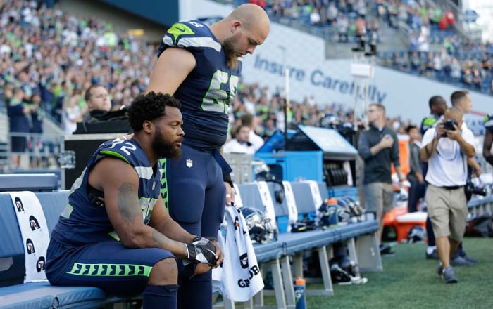 Teammate Justin Britt stood next to Michael Bennett as he sat during the anthem in Seattle.